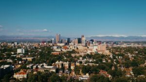 Aerial view of downtown Denver, Colorado with residential neighborhoods in the foreground. Learn how how interest rates affect your mortgage.