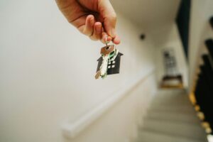 First-time homebuyer holding their keys to their new home.