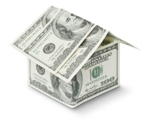 House made of hundred-dollar bills representing real estate investment or mortgage financing.